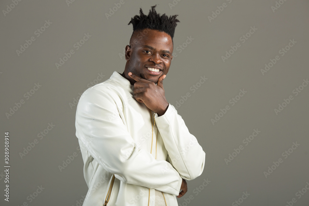 handsome african man in a white jacket on a gray background handsome african man in a white jacket on a gray background