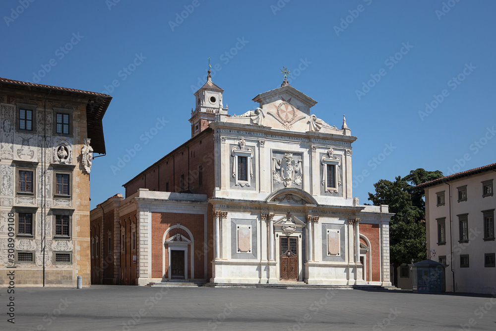 View on the square in front of italian church. Ornate facade of Church of Santo Stefano dei Cavalieri, Piazza dei Cavalieri. No people. Pisa, Italy