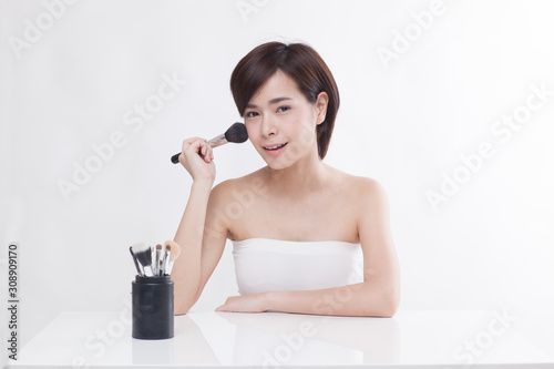 Young beautiful Asian short hair female model on white background