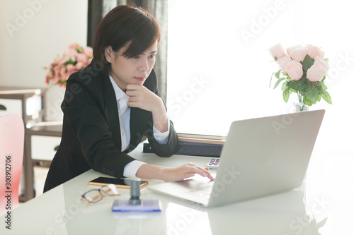 Young Asian short hair female model in formal dress which is good for business purpose