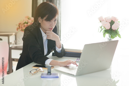 Young Asian short hair female model in formal dress which is good for business purpose