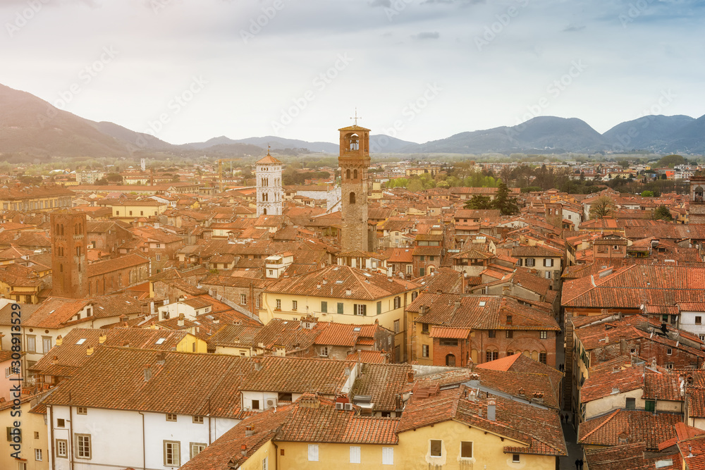 Panoramic view from Guinigi tower with beautiful medieval town Lucca in morning sunlight, Tuscany, Italy