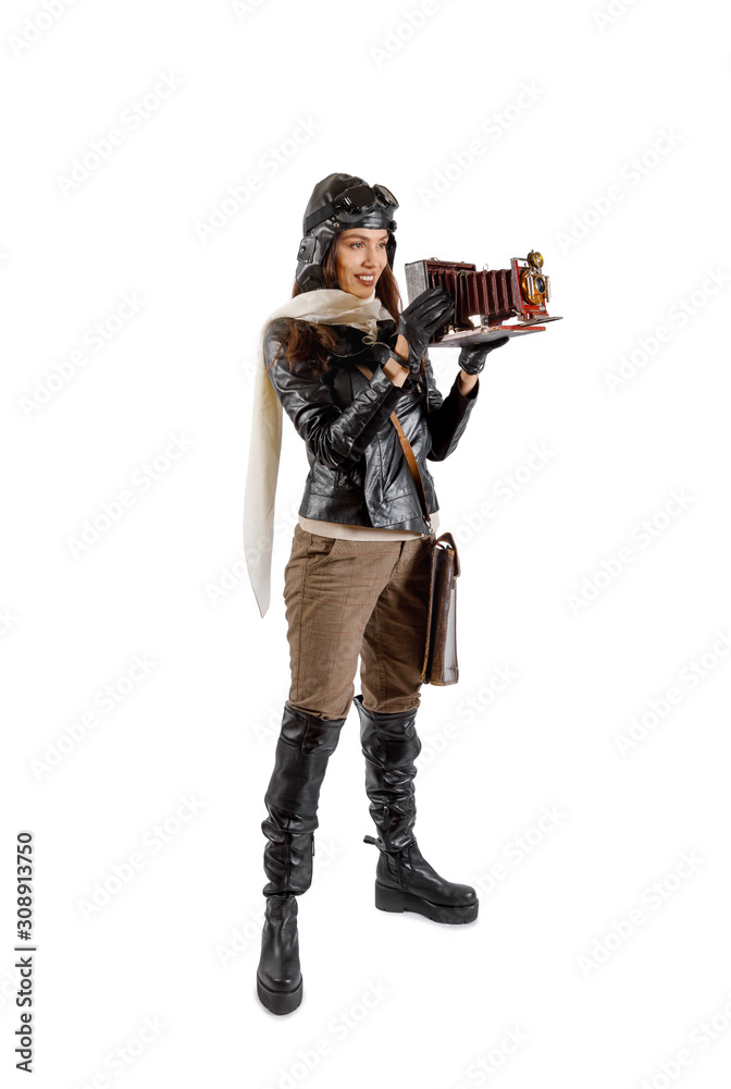 Pretty brunette girl in a retro aviator costume with vintage camera Pretty brunette girl in a retro aviator costume with vintage camera