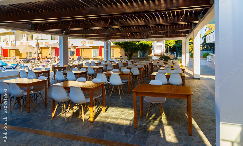 open-air restaurant in resort Greek hotel, wooden roof,