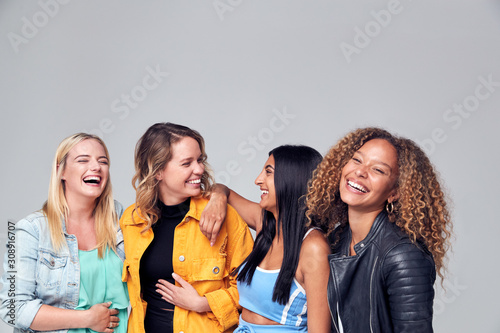 Group Studio Portrait Of Multi-Cultural Female Friends Smiling Into Camera Together photo