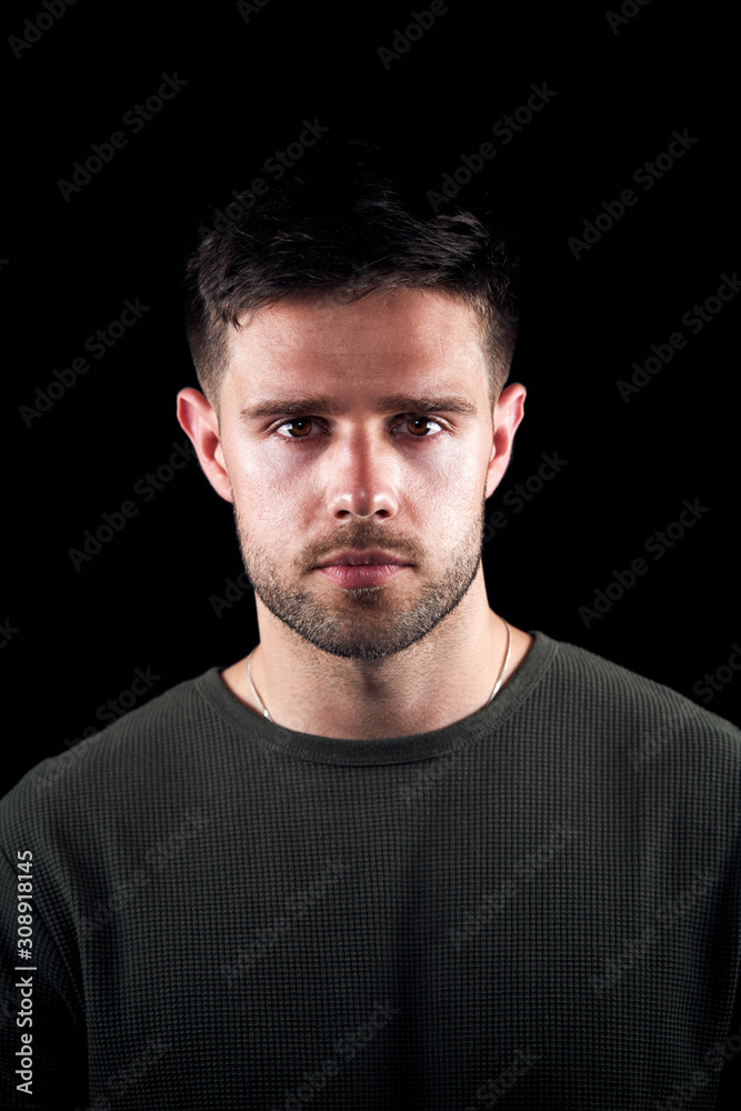 Studio Portrait Of Young Man With Serious Expression Looking At Camera Studio Portrait Of Young Man With Serious Expression Looking At Camera