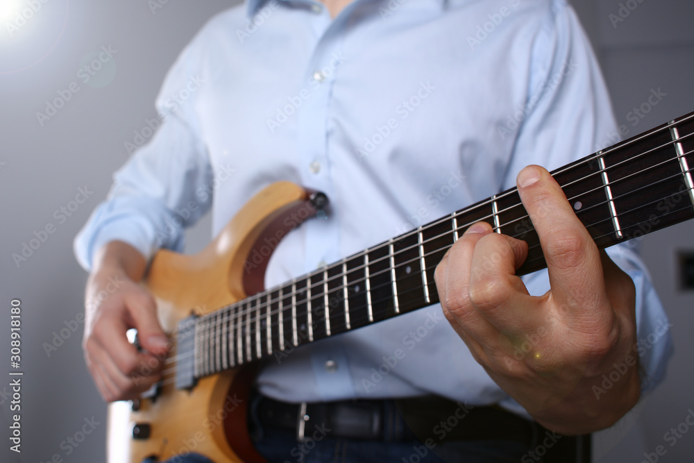 Male arms playing classic shape electric guitar Male arms playing classic shape electric guitar