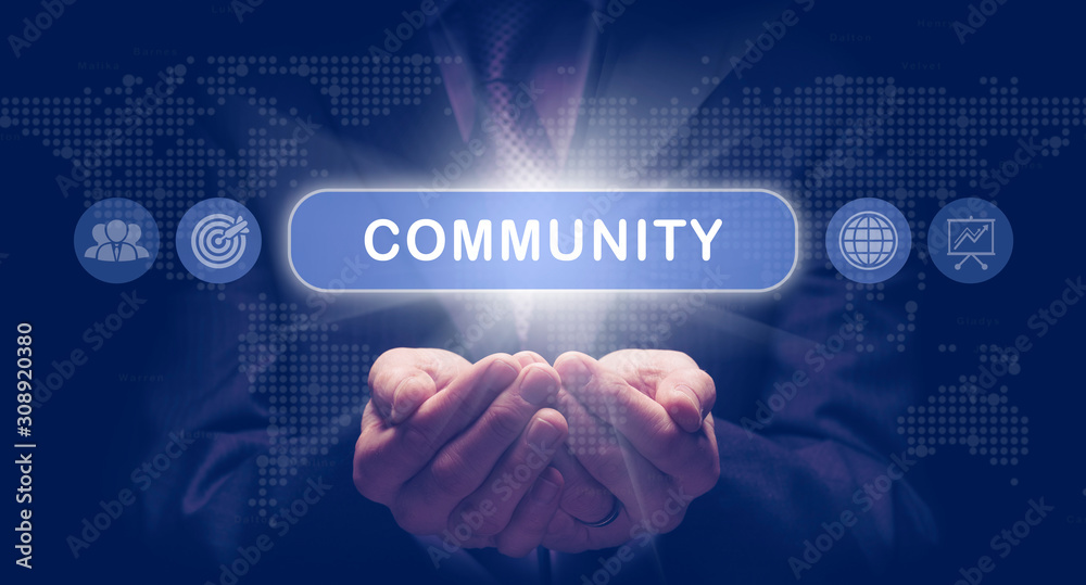 Businessmans cupped hands holding a Community business concept on a computerised display. Businessmans cupped hands holding a Community business concept on a computerised display.