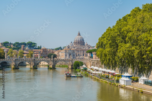 The Tiber River, the Sant'Angelo Bridge and the dome of St. Peter's Basilica in Rome, Italy