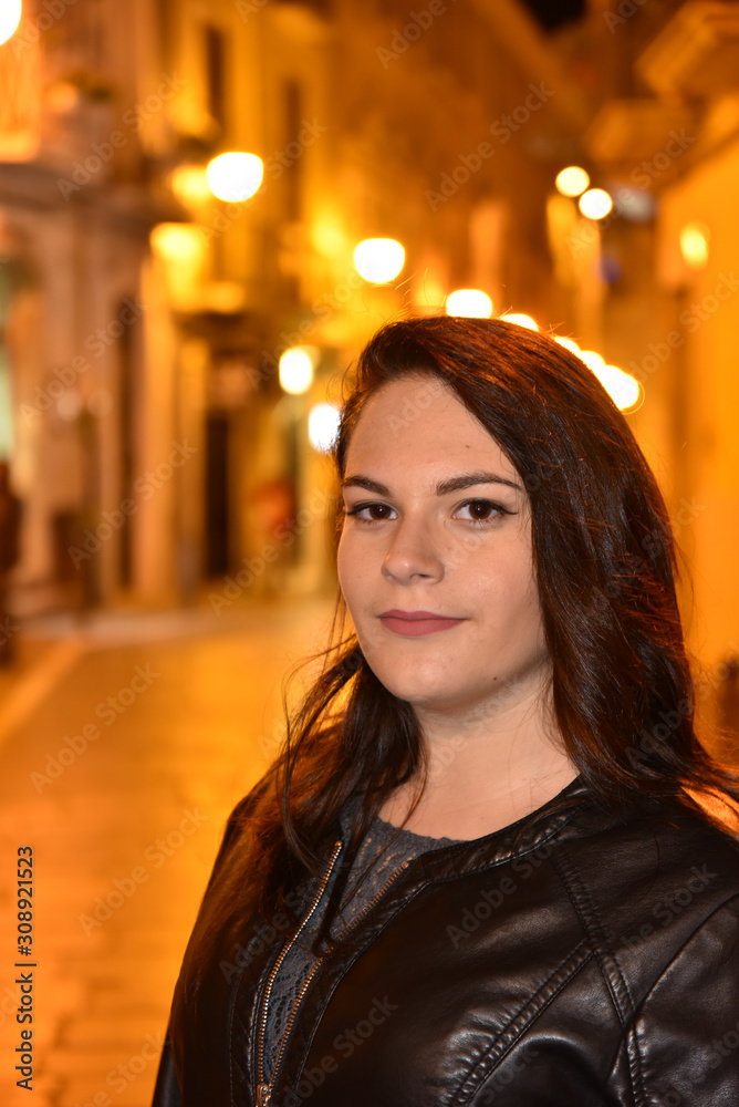 Night Portrait of Young Beautiful Woman in the City Illuminated by Lights Background Night Portrait of Young Beautiful Woman in the City Illuminated by Lights Background