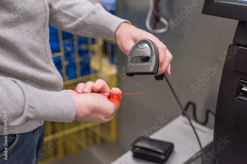 Man paying at the self-service counter entering credit card pin code for security password in credit card swipe machine. shopping time