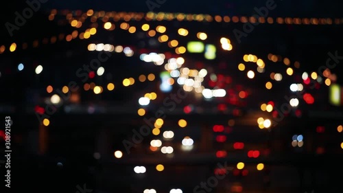 Defocused night city car traffic lights. Color blurred bokeh of moving transport and typical city view