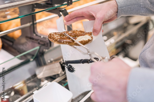 Man buying pretzels in a pastry shop for Christmas