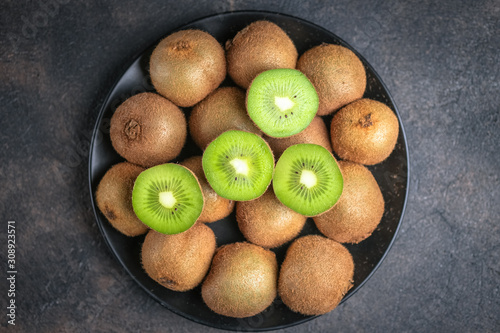 Fresh ripe kiwi fruit on  a dark  background. Detox diet. Copy space.