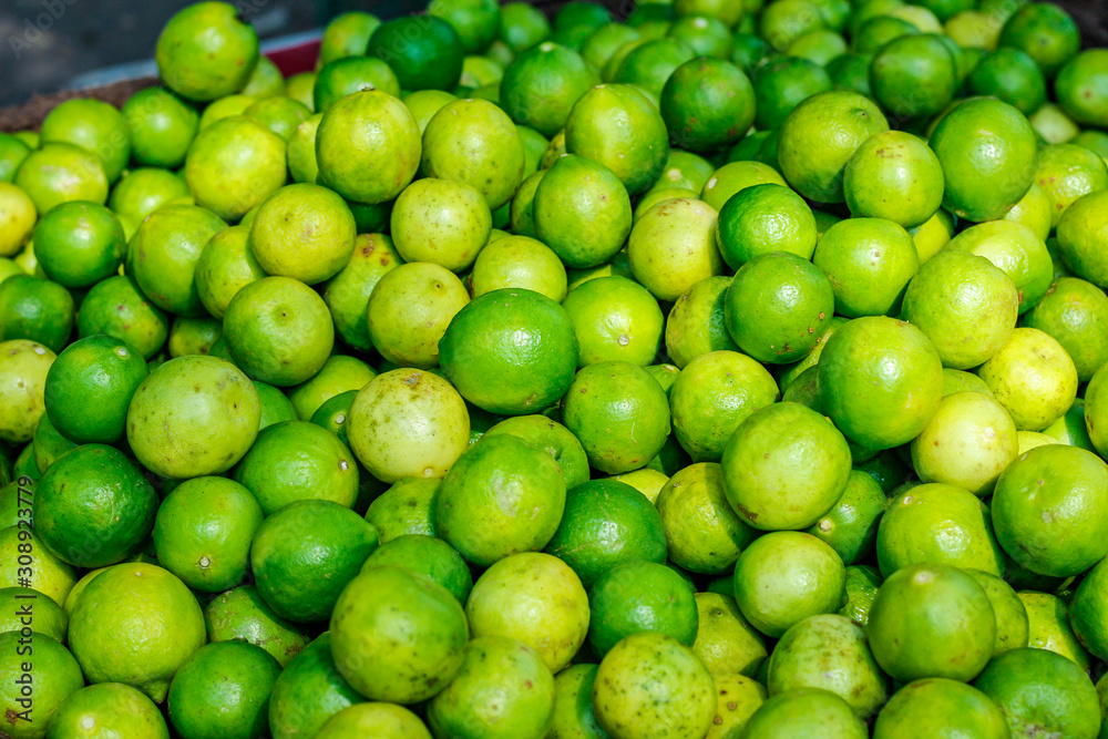 Green and yellow lemon in indian vegetable market Green and yellow lemon in indian vegetable market