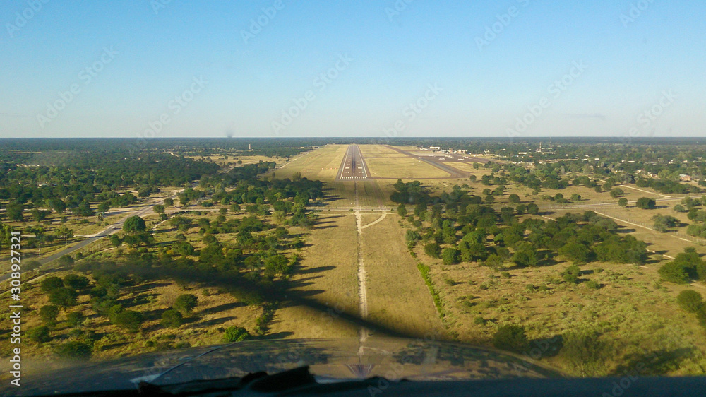 Fototapeta premium Approaching Maun international Airport surroundings in Botswana, airstrip in the distance