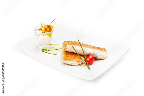 Two burritos served on a white dish with sauce, decorated by red tomato,  isolated on a white background.