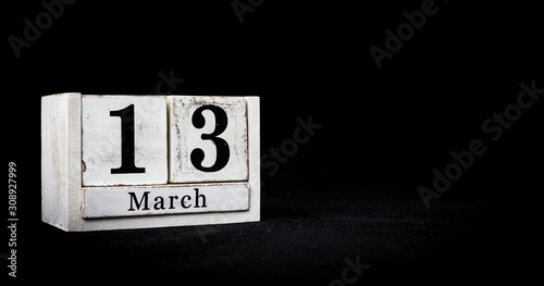 March 13th, Thirteenth of March, Day 13 of month March - white calendar blocks on black textured background with empty space for text.