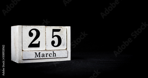 March 25th, Twenty-fifth of March, Day 25 of month March - white calendar blocks on black textured background with empty space for text.