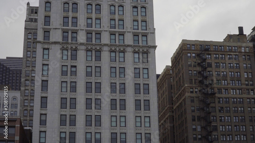 Typical generic day time establishing shot of an urban apartment building facade. Fire escape on outside of facade for safety