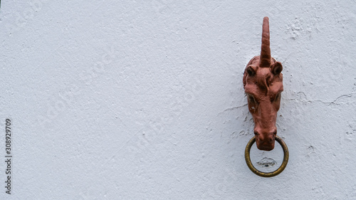 Wooden horse head (unicorn) on a wall photo