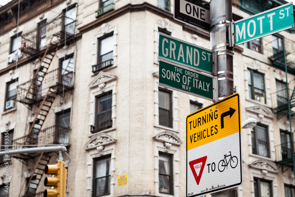 Little Italy, New York City, USA. Street signs and architecture of Little Italy, NYC, on the corner of Mott St. and Grand St.