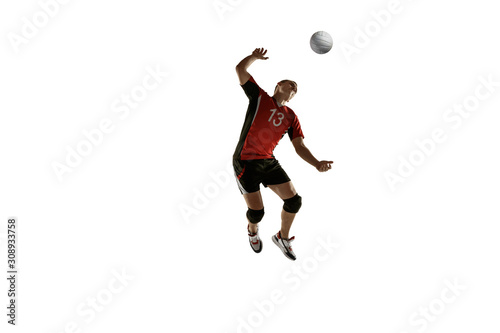 Young caucasian volleyball player placticing isolated on white background. Male sportsman training with the ball in motion and action. Sport, healthy lifestyle, activity, movement concept. Copyspace.
