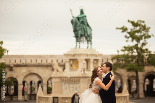 Young beautiful stylish pair of newlyweds hugging by the Fisherman's Bastion in Budapest, Hungary