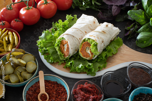 Cig kofte (raw meatball in Turkish) with lettuce, tomato, pickle and lemon, hot Chee kofta