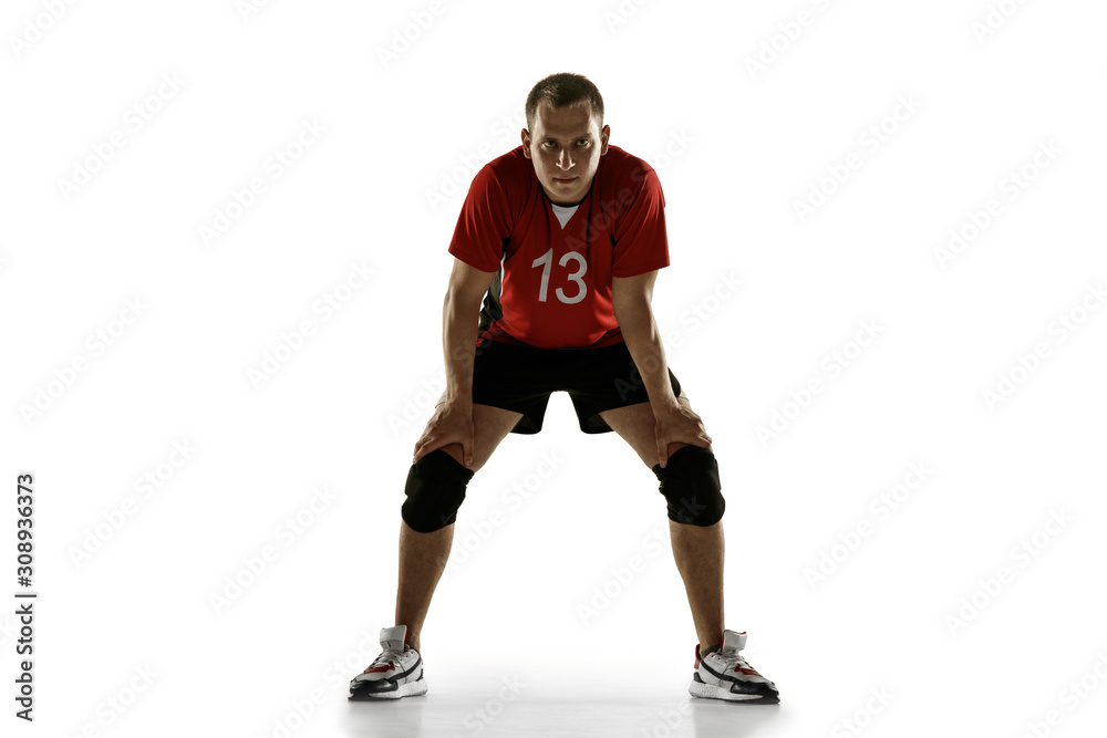 Young caucasian volleyball player placticing isolated on white background. Male sportsman training with the ball in motion and action. Sport, healthy lifestyle, activity, movement concept. Copyspace.