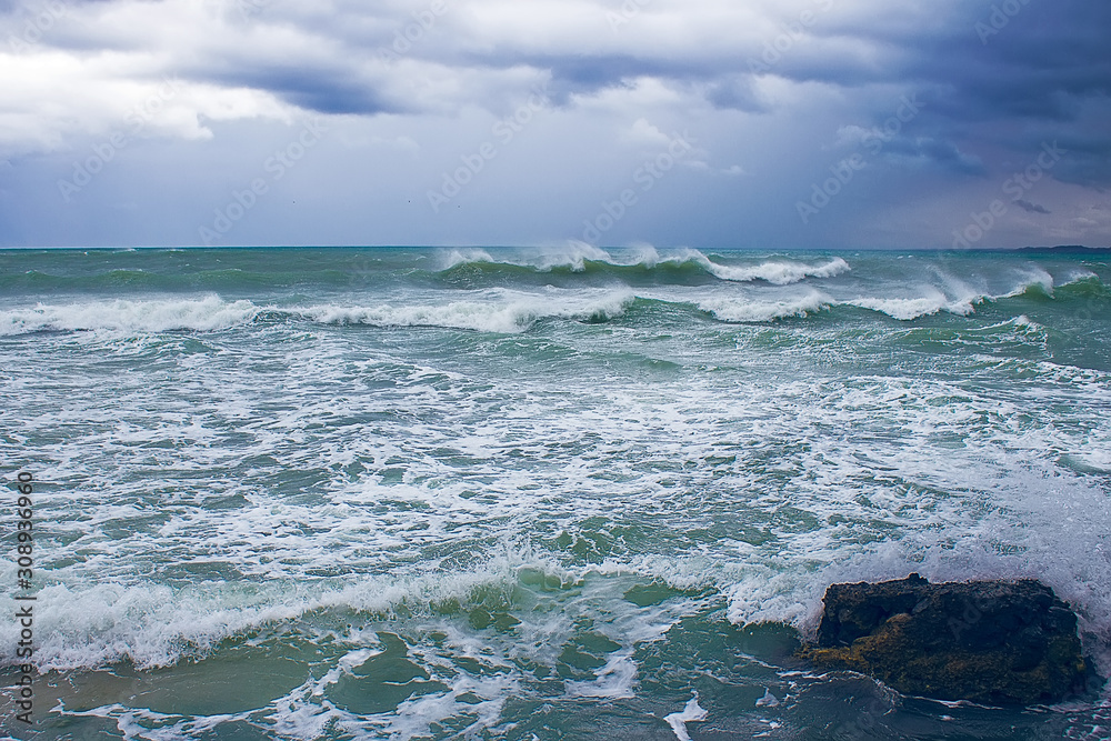 Stormy Mediterranean sea in Hammamet, Tunisia, dark clouds and blue waves