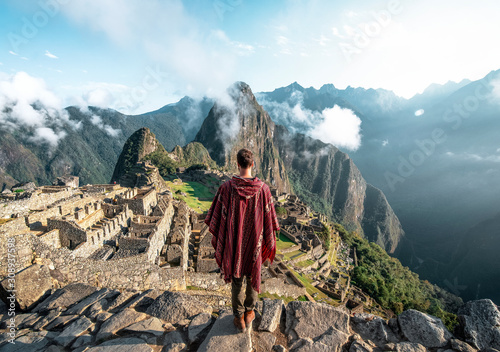  Man observing the ruins of Machu Picchu photo