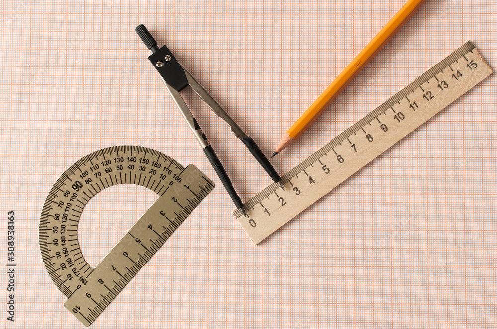Geometry set with compass,pencil,ruler on graph paper Geometry set with compass,pencil,ruler on graph paper