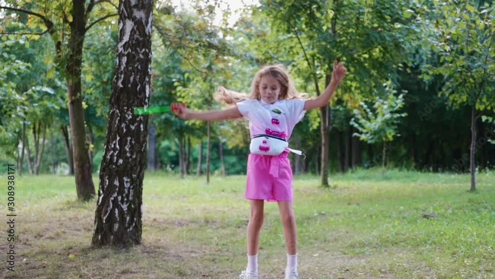 Little girl with soap bubbles. Young beautiful girl blowing bubbles outdoors Little girl with soap bubbles. Young beautiful girl blowing bubbles outdoors