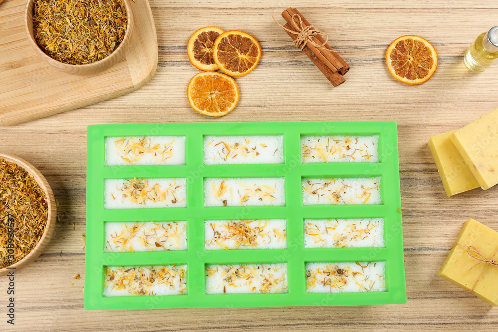 Flat lay composition with natural handmade soap and ingredients on wooden background Flat lay composition with natural handmade soap and ingredients on wooden background