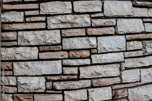 Stunning brick wall of Jerusalem stones in the beautiful garden near Herzl's cemetery. Jerusalem, Israel.