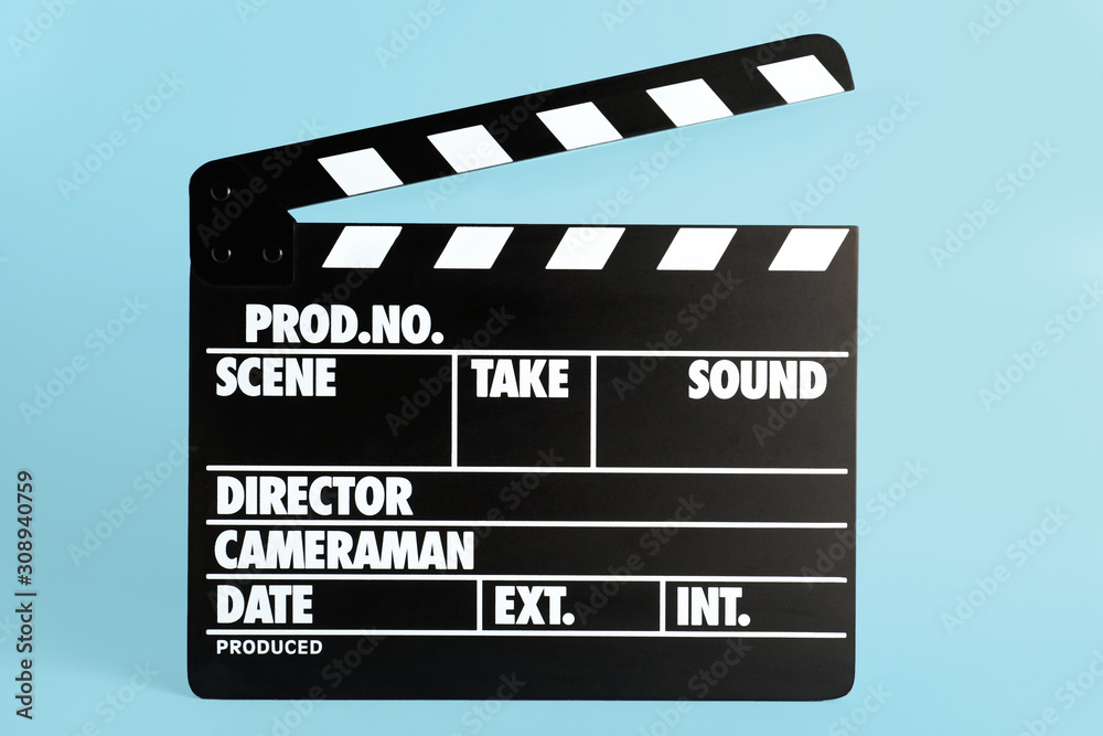 Fototapeta premium Clapper board on light blue background. Cinema production