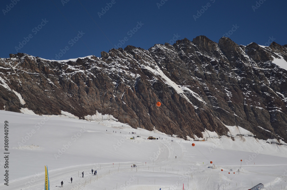 People skiing at the top of the Jungfraujoch peak.