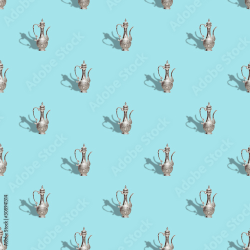 Seamless pattern with vintage old teapot on trendy blue background, isometric style © melya31