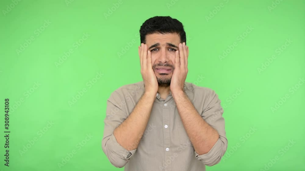 How could you? Frustrated upset brunette man with bristle in shirt raising hands with indignant annoyed expression, asking why how, reproaching for mistake. indoor studio shot, green background How could you? Frustrated upset brunette man with bristle in shirt raising hands with indignant annoyed expression, asking why how, reproaching for mistake. indoor studio shot, green background