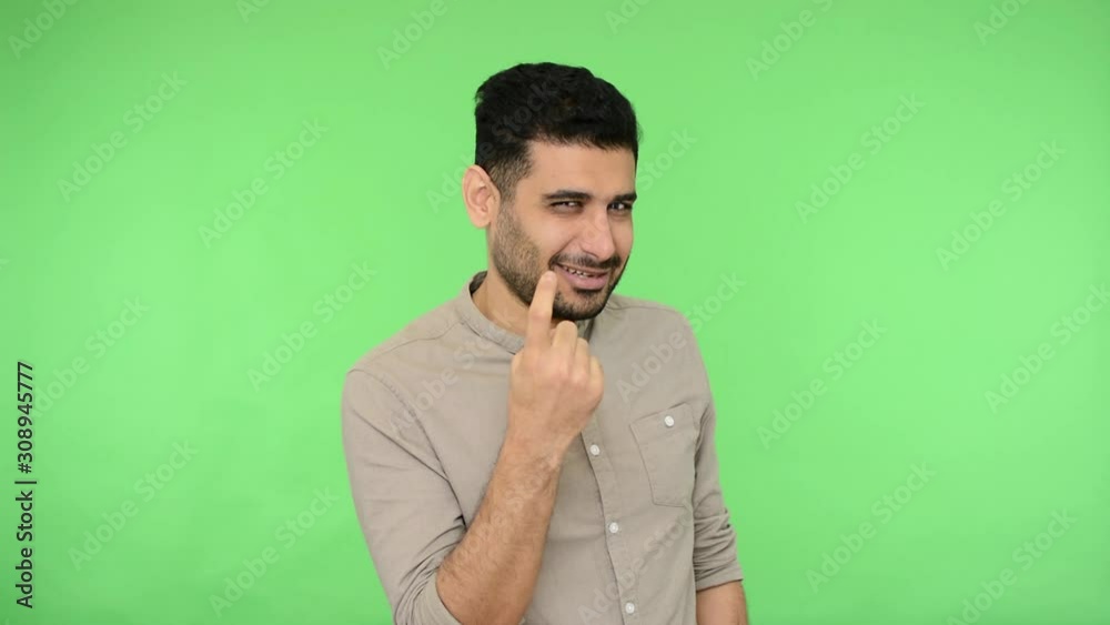 Hey you, beauty, come to me! Handsome brunette man with bristle in shirt looking with alluring eyes and beckoning to approach, doing inviting gesture. indoor studio shot, green background, chroma key Hey you, beauty, come to me! Handsome brunette man with bristle in shirt looking with alluring eyes and beckoning to approach, doing inviting gesture. indoor studio shot, green background, chroma key