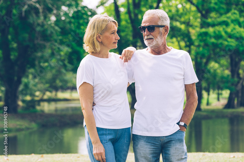 Couples Caucasian Elderly sitting in the park talk to each other with smile