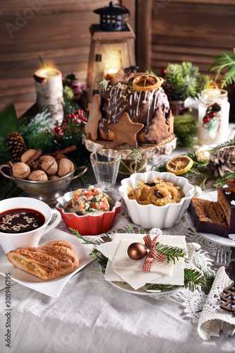 Christmas Eve table with traditional dishes and cakes