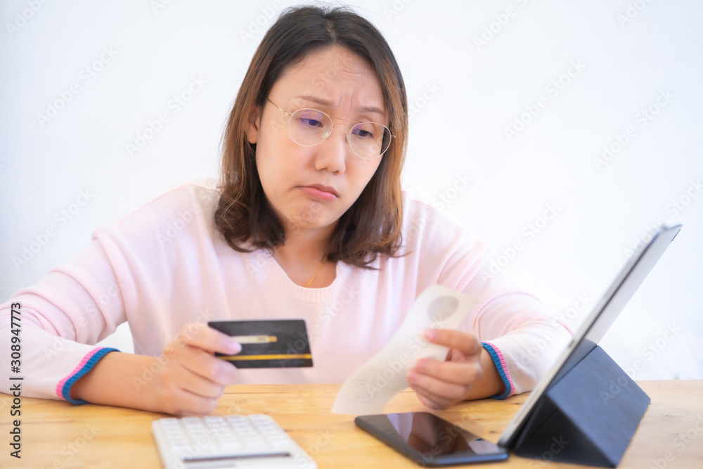 Confused portrait young woman holding credit cards having problem online payment with credit card making rejected unsecure online payment. credit card debt payment Confused portrait young woman holding credit cards having problem online payment with credit card making rejected unsecure online payment. credit card debt payment