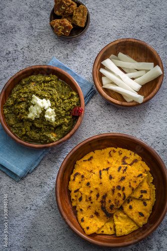 Makki ki roti with sarson ka saag, popular north indian main course menu usually prepared in winter season, using cornmeal breads and mustard leaves vegetables