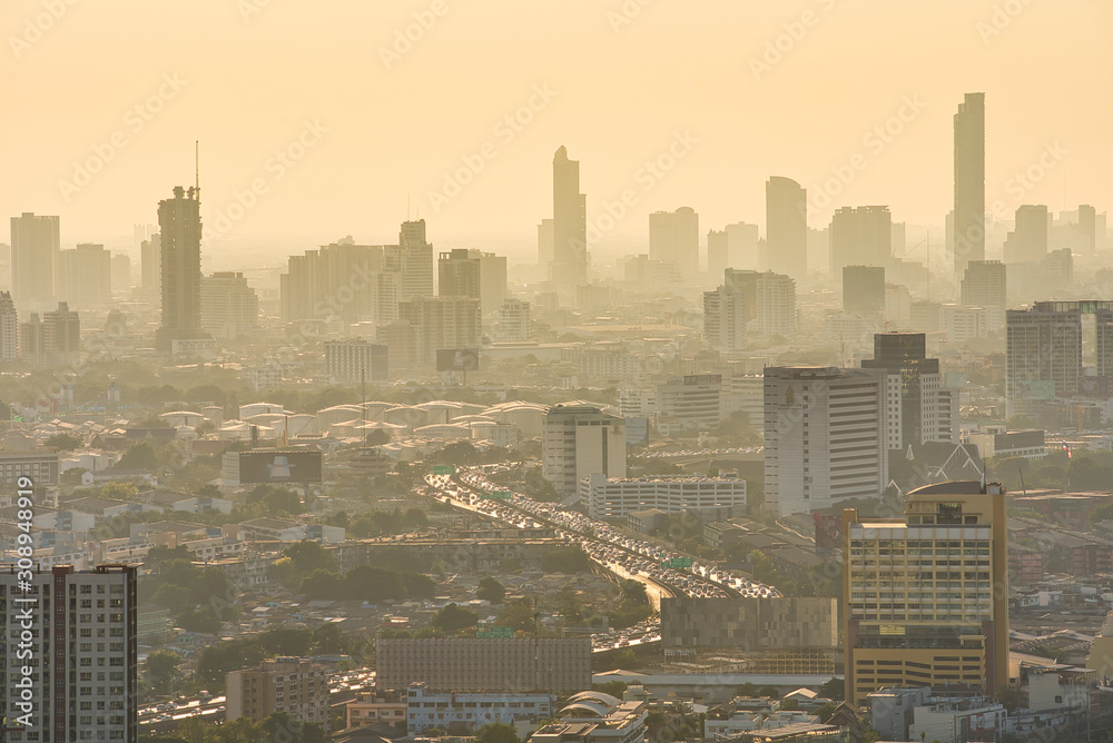 Fototapeta premium Bangkok / Thailand - 8 March 2019: Bird's eye view to show the beautiful sky and heavy traffic above the city view of Bangkok that is full of harmful PM 2.5 dust that is harmful to the body.