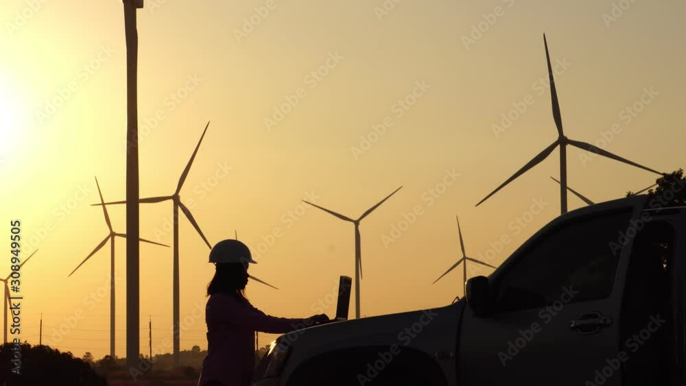 Engineers are monitoring the wind turbine system with a tablet footage 4K