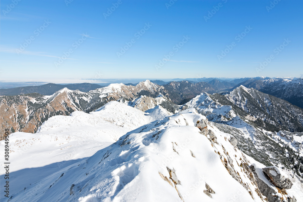 Snow-covered alpine landscape in the Ammergau Alps from summit of Hochplatte mountain at a beautiful early winter day. Bavaria, Germany