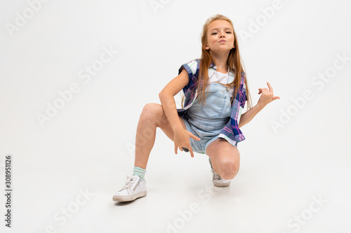 Photography stylish girl improvises guitar with hands on a white background