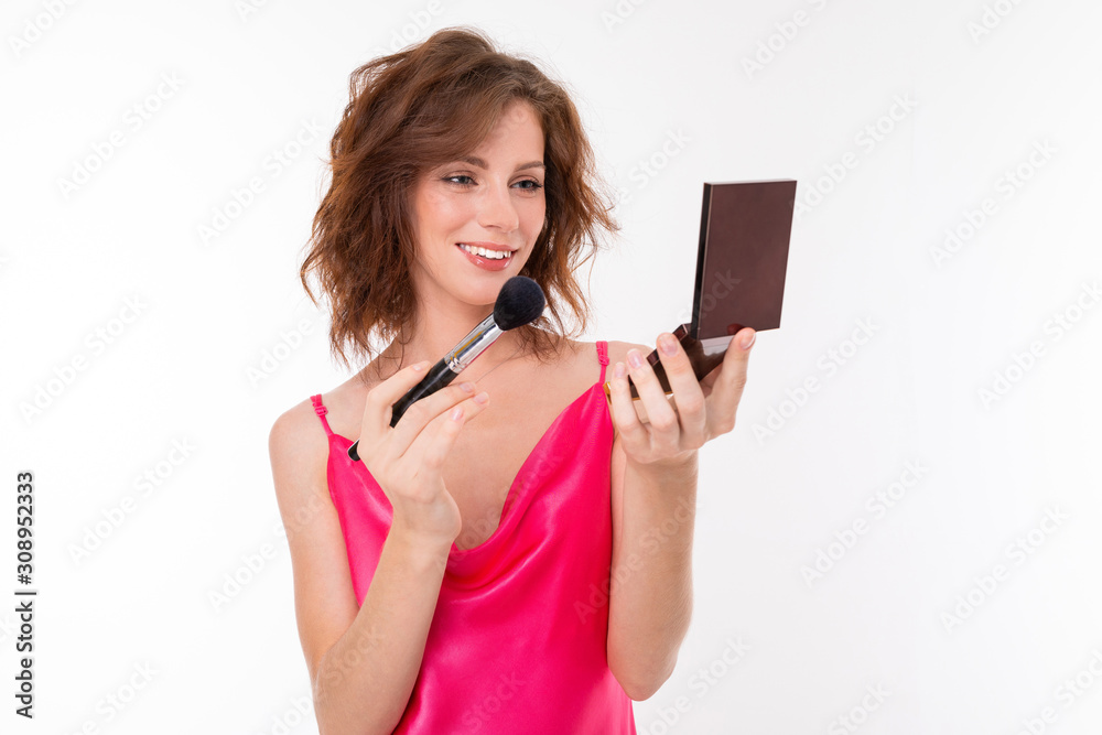 Young beautiful girl do makeup with little mirror isolated on white background Young beautiful girl do makeup with little mirror isolated on white background